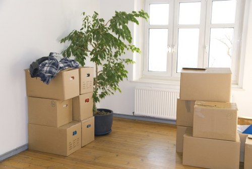 Packed boxes and furniture prepared for transport by removal van in Streatham