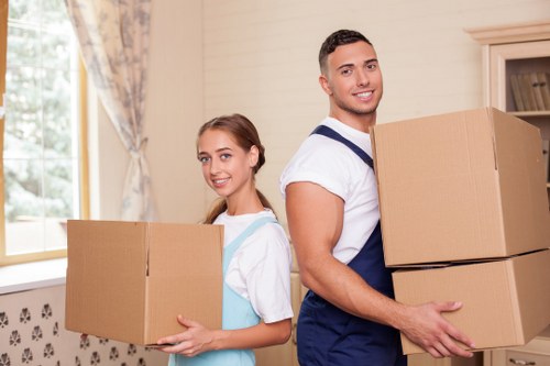 Packed moving boxes and furniture prepared for transport in Streatham